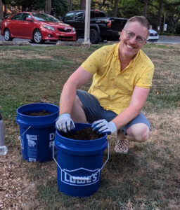 man filling his micro-gardening buckets with fresh top soil